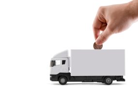 Putting,Coin,Into,The,White,Cargo,Delivery,Truck,On,White